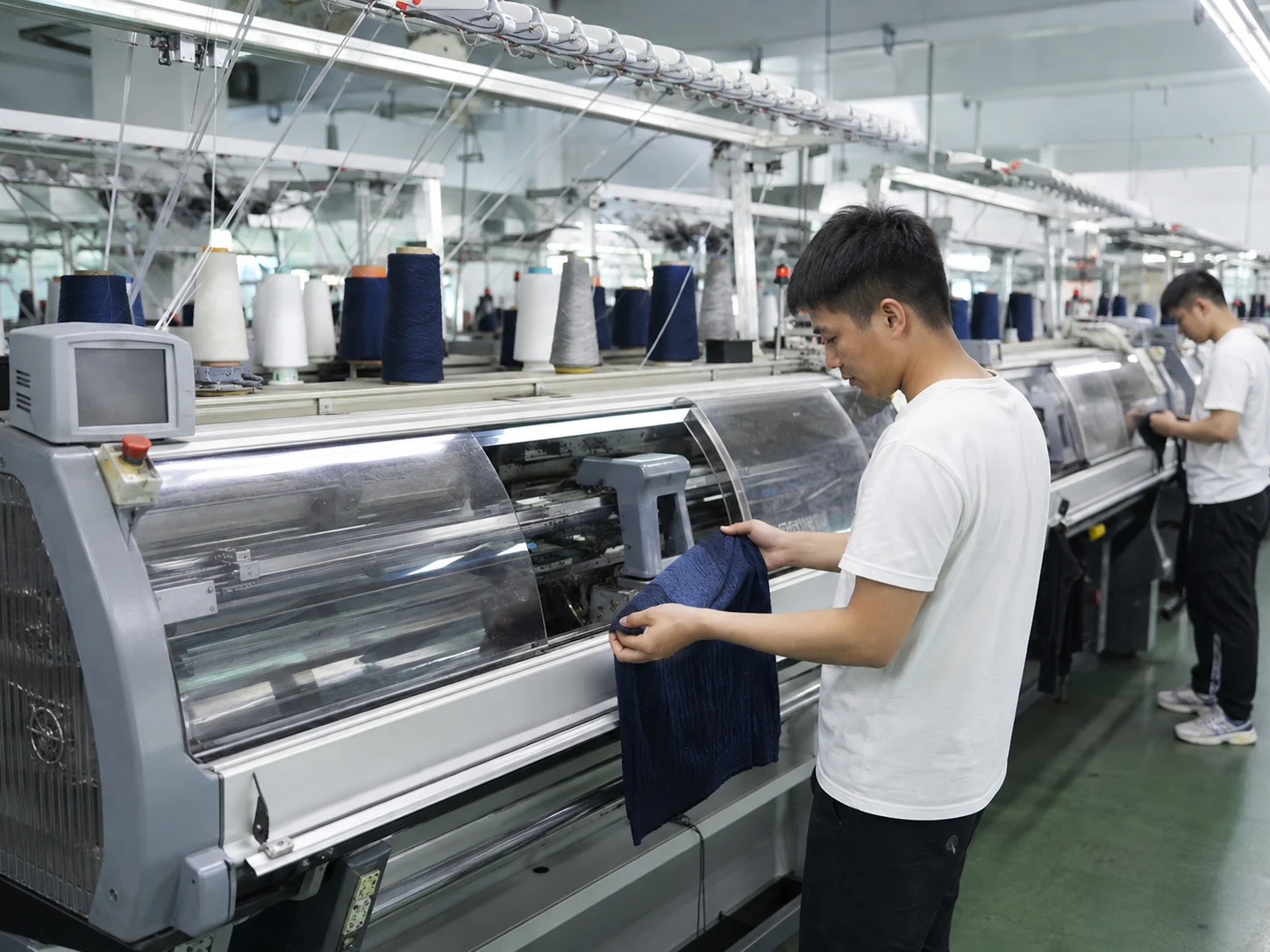 Computerized flat knitting production at an OEM knitwear manufacturer